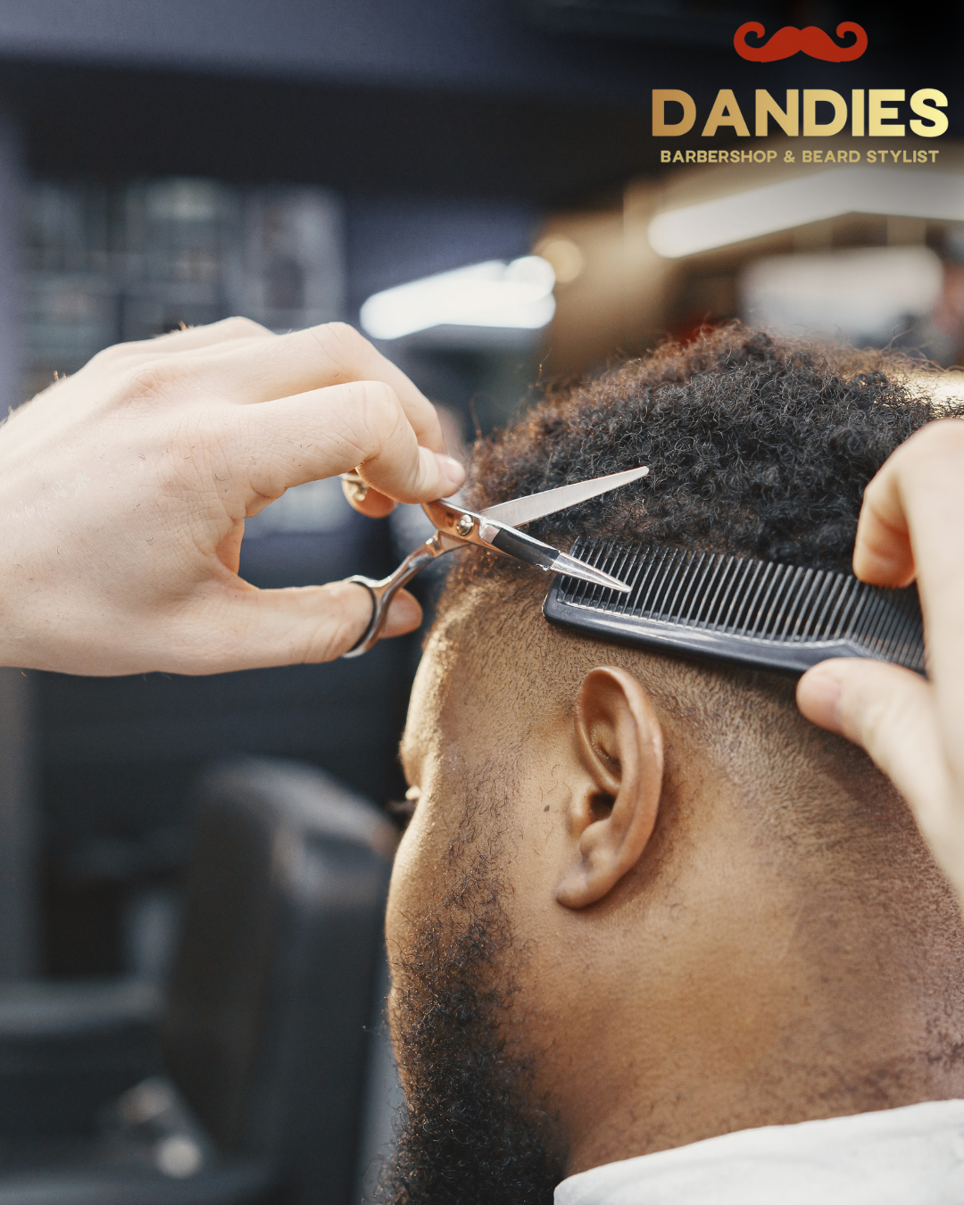 Black barber shaping hairline with clippers